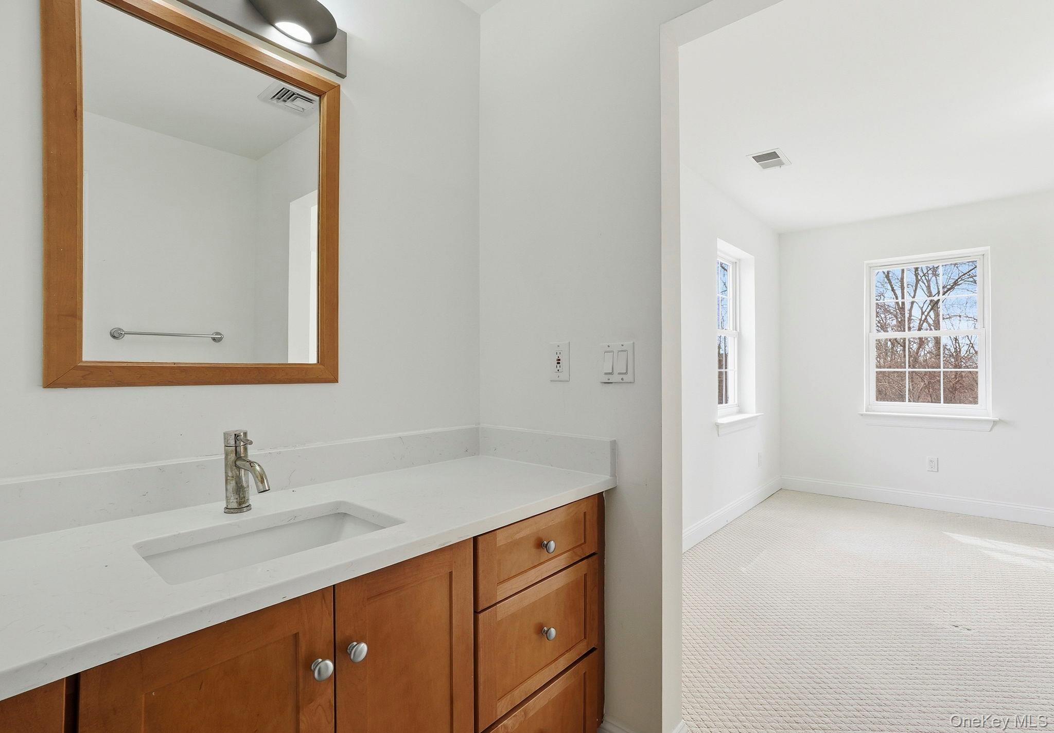 37 Willets Way Newburgh, NY 12550 - Photo 36 of 48 a bathroom with a sink vanity and mirror