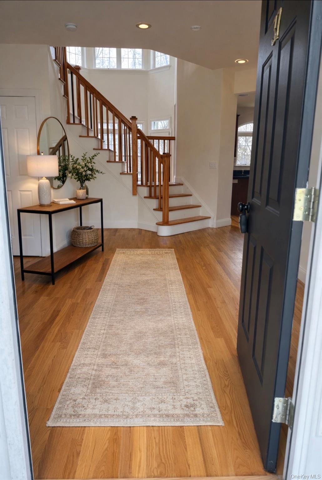 37 Willets Way Newburgh, NY 12550 - Photo 5 of 48 a view of staircase with lots of frames on wall and a chandelier