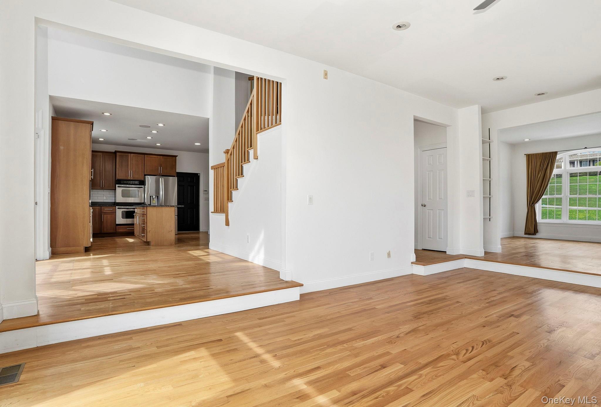 37 Willets Way Newburgh, NY 12550 - Photo 9 of 48 a view of a room with wooden floor and a kitchen space