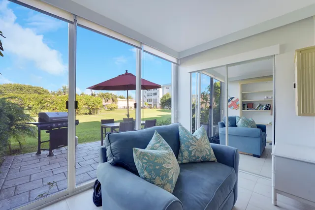 a living room with furniture and a floor to ceiling window