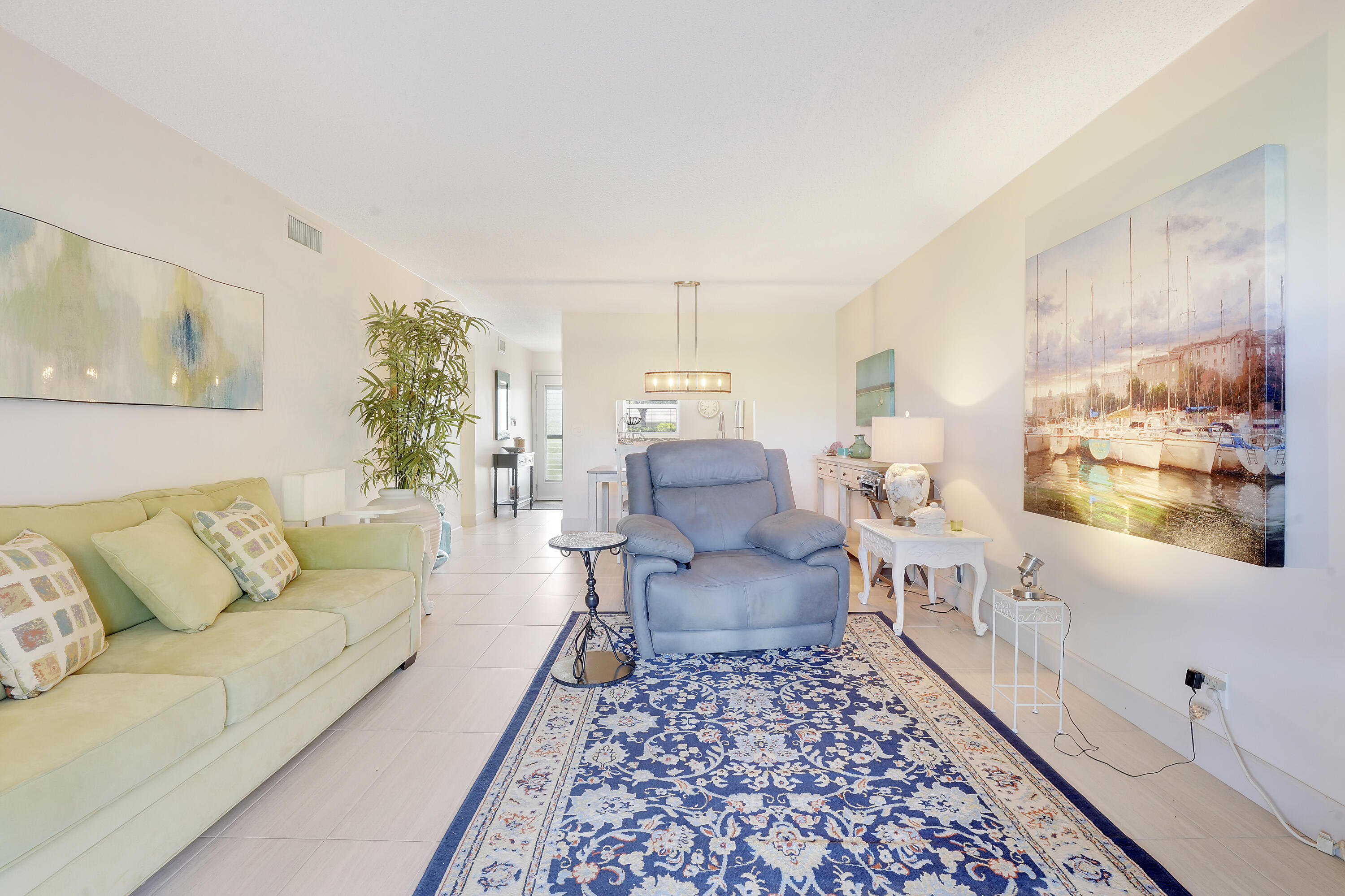 2400 Northeast 1st Lane, Unit 1020 Boynton Beach, FL 33435 - Photo 12 of 34 a living room with furniture and a large window