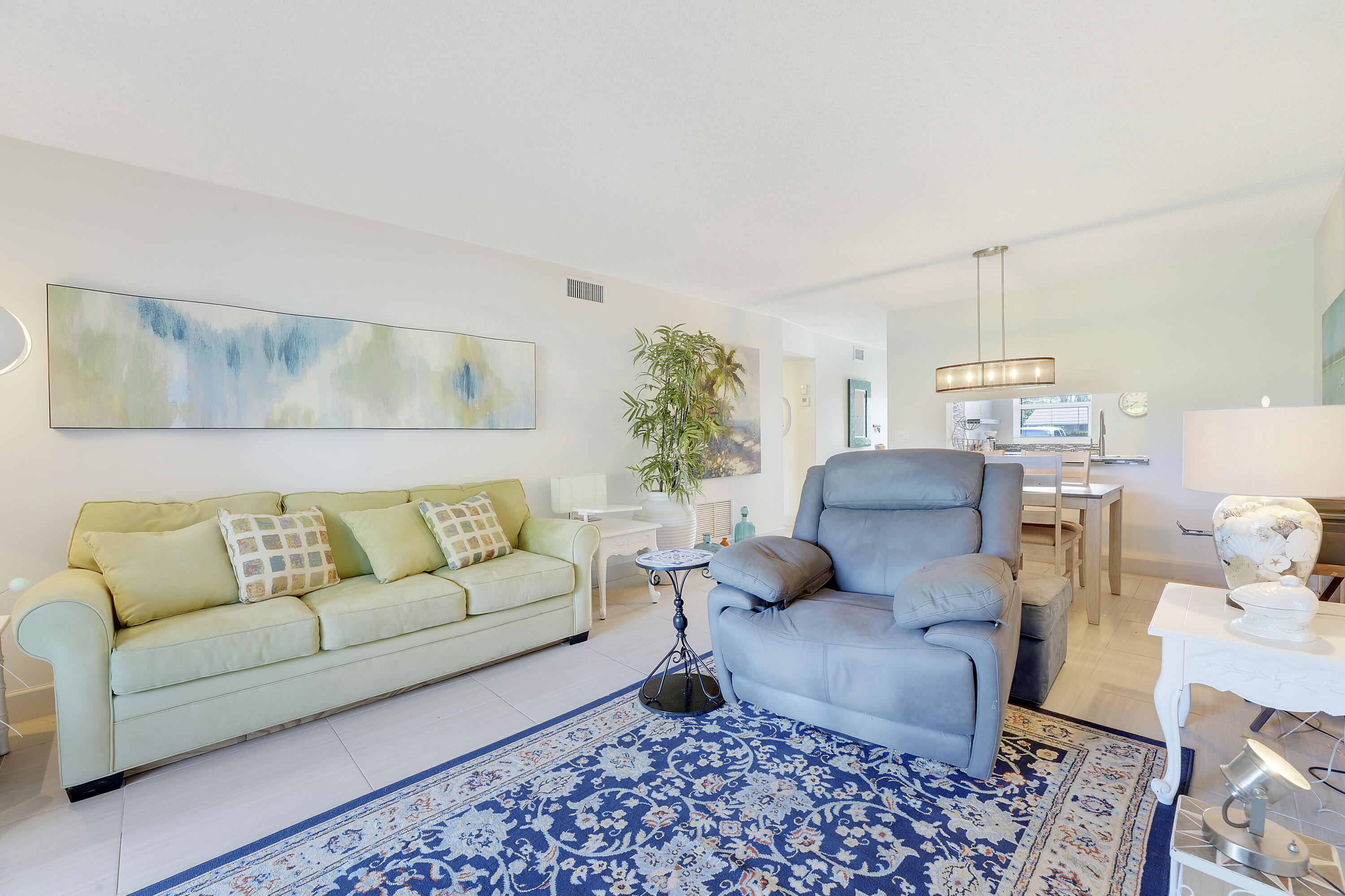 2400 Northeast 1st Lane, Unit 1020 Boynton Beach, FL 33435 - Photo 13 of 34 a living room with furniture and a rug