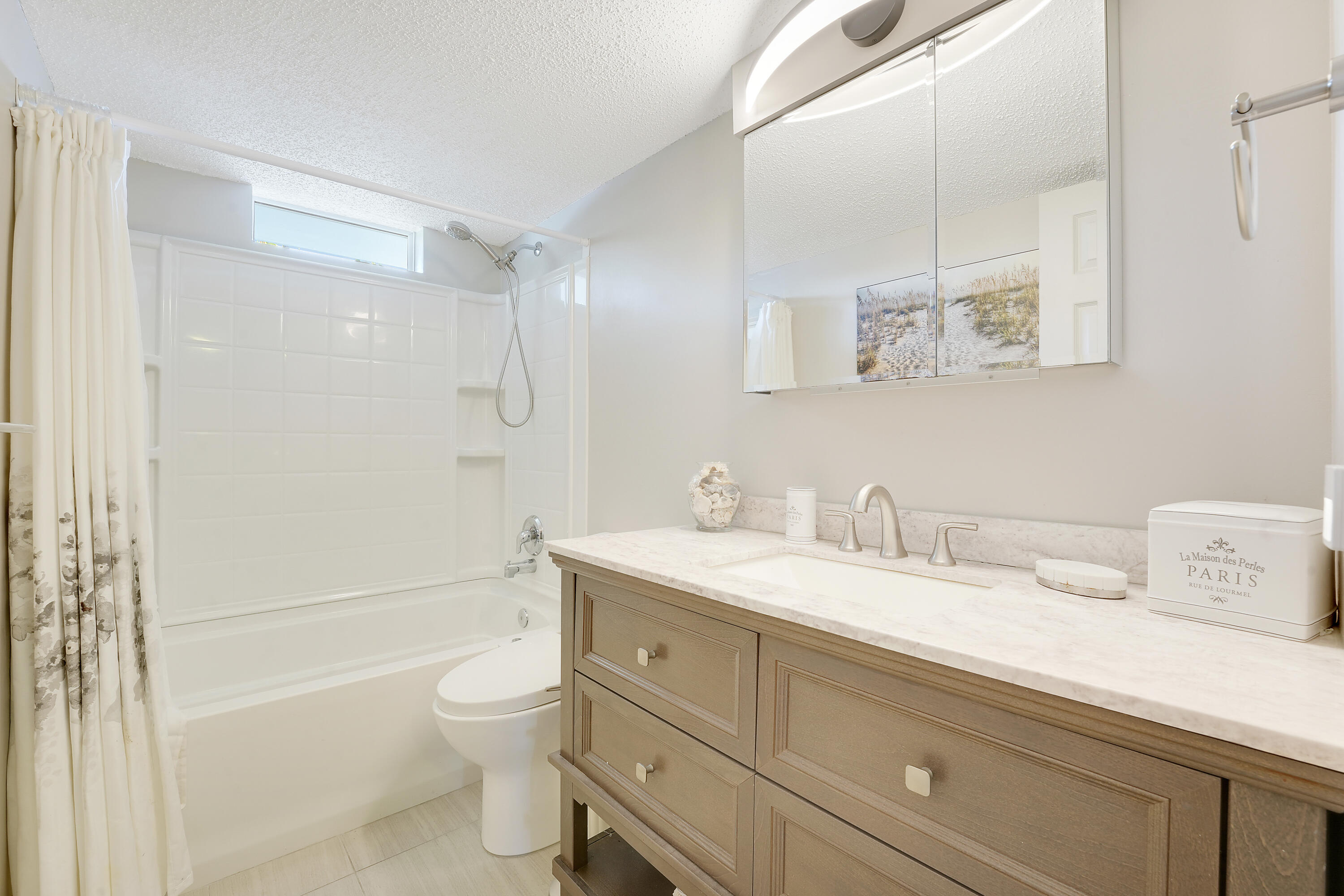 2400 Northeast 1st Lane, Unit 1020 Boynton Beach, FL 33435 - Photo 14 of 34 a bathroom with a granite countertop sink a toilet and a bathtub