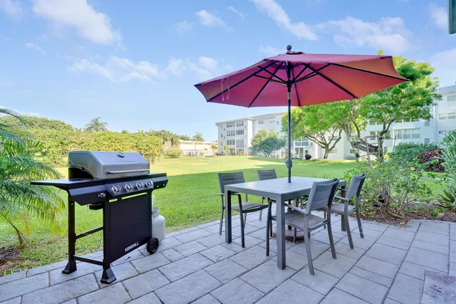 an outdoor space with furniture and umbrella