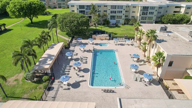 a view of a backyard with plants and outdoor seating