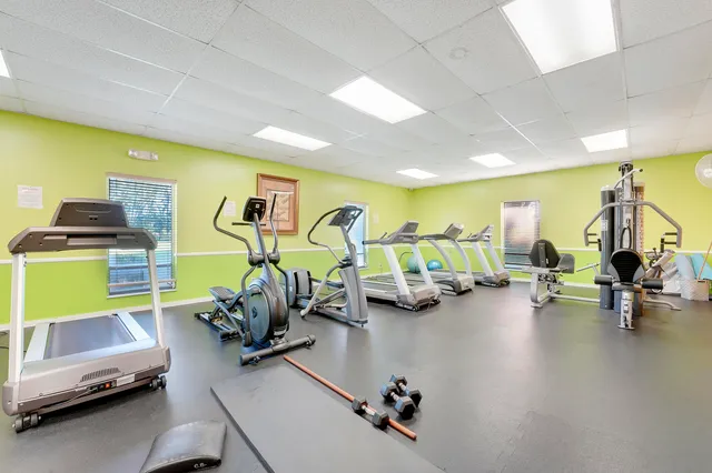 a living room with furniture a flat screen tv and kitchen view