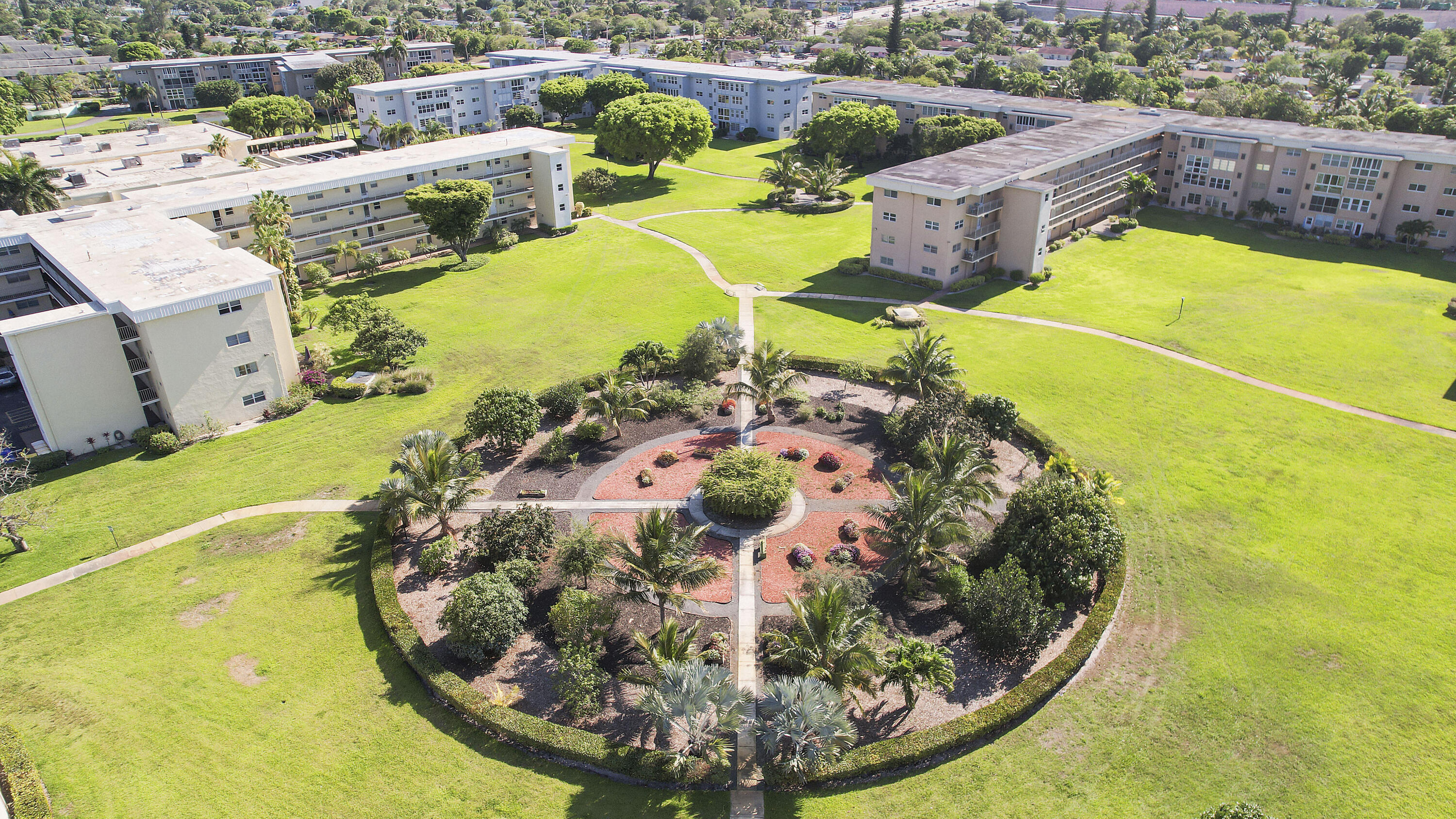 2400 Northeast 1st Lane, Unit 1020 Boynton Beach, FL 33435 - Photo 30 of 34 a view of a swimming pool with a yard