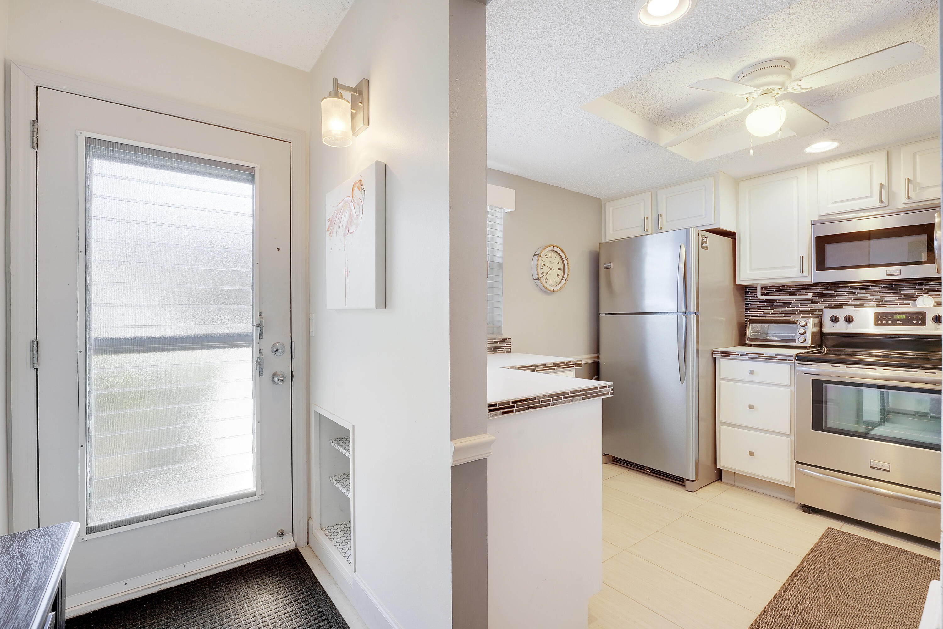2400 Northeast 1st Lane, Unit 1020 Boynton Beach, FL 33435 - Photo 4 of 34 a kitchen with a refrigerator and a sink