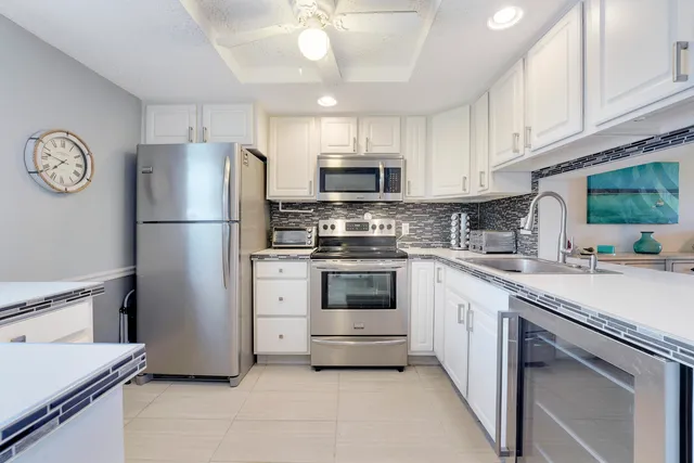 a kitchen with cabinets stainless steel appliances and a counter space