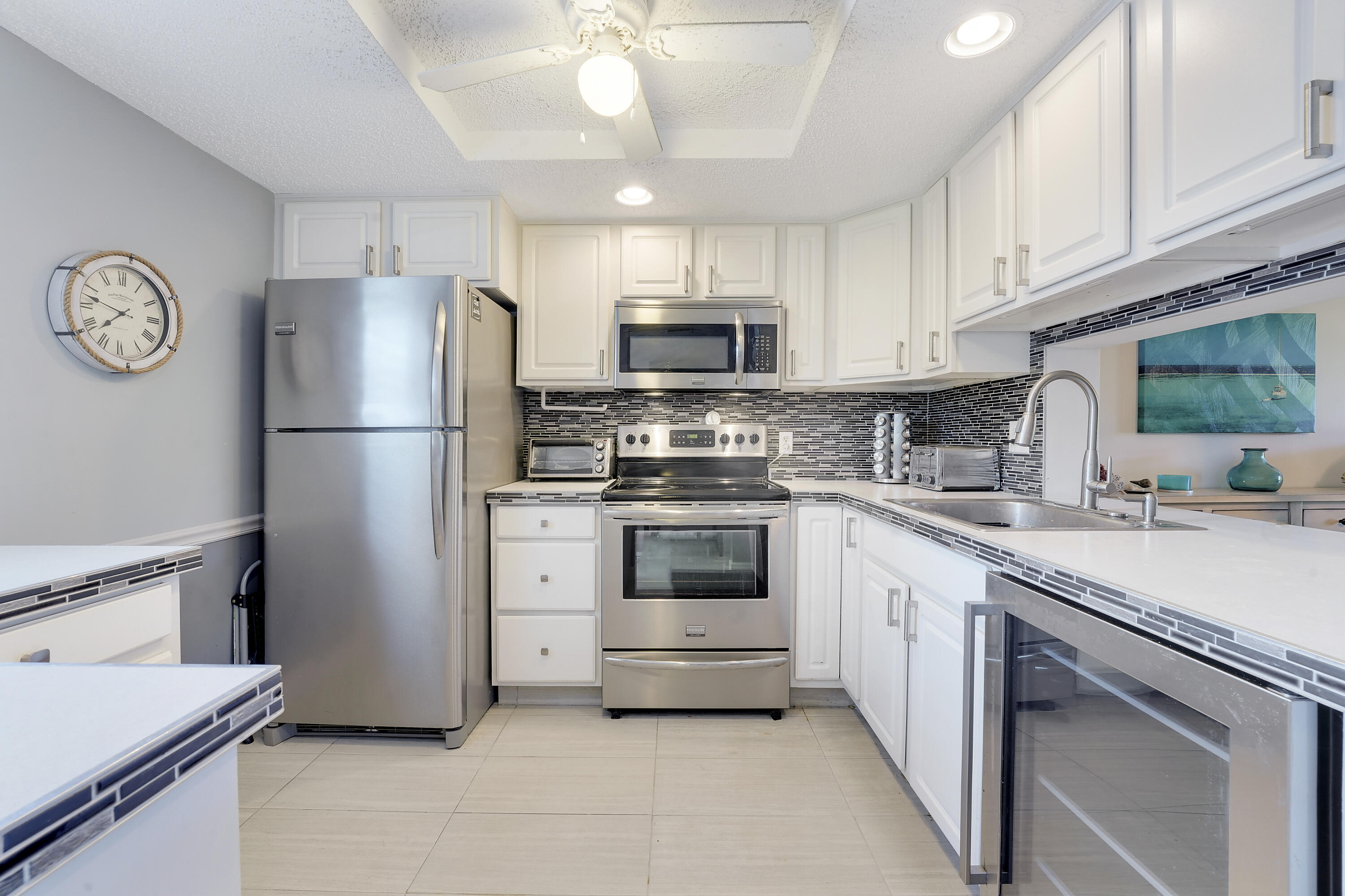 2400 Northeast 1st Lane, Unit 1020 Boynton Beach, FL 33435 - Photo 6 of 34 a kitchen with cabinets stainless steel appliances and a counter space