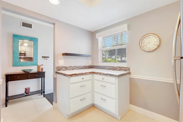 a kitchen with granite countertop a stove and a sink