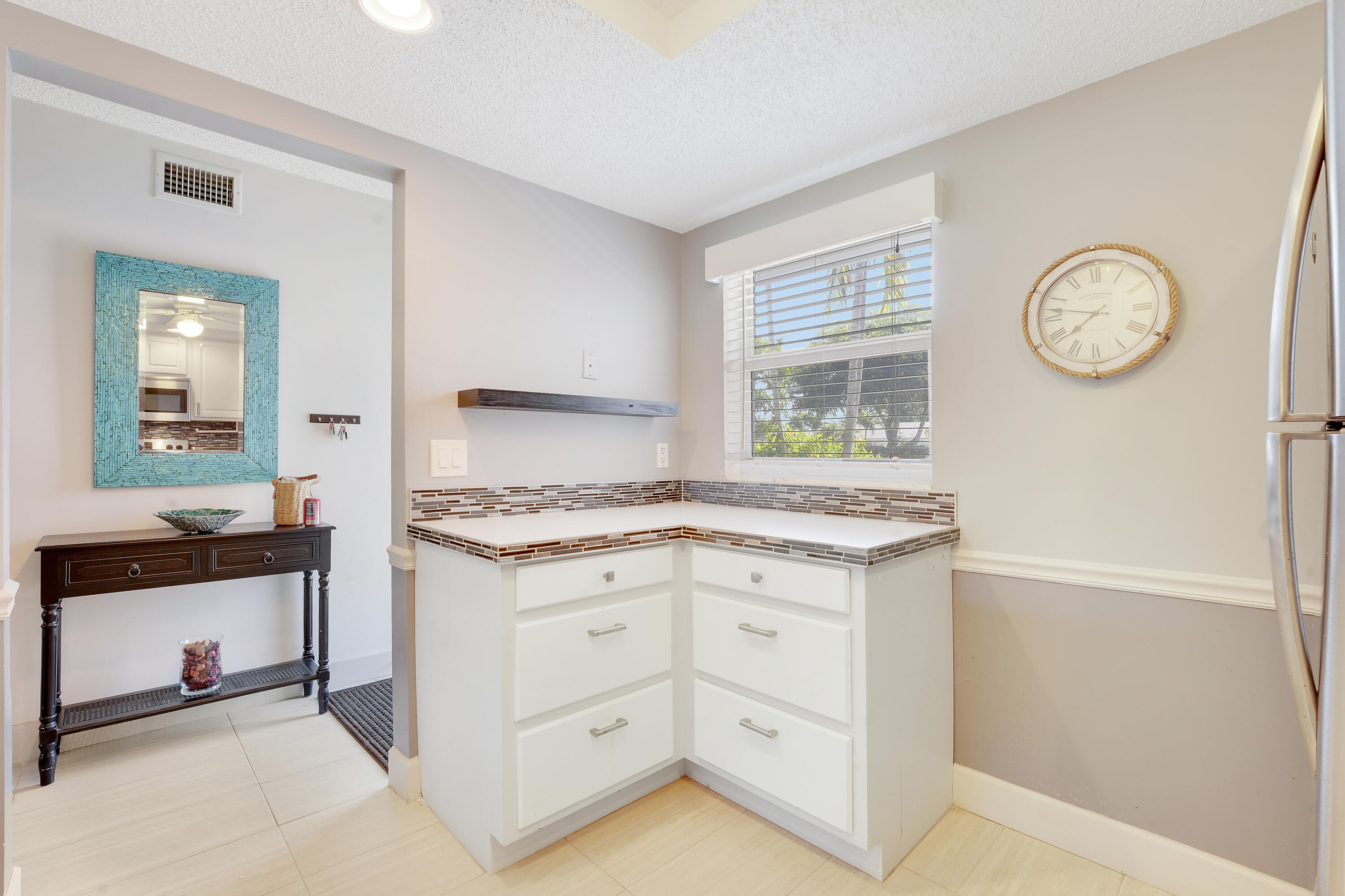 2400 Northeast 1st Lane, Unit 1020 Boynton Beach, FL 33435 - Photo 7 of 34 a kitchen with granite countertop a stove and a sink