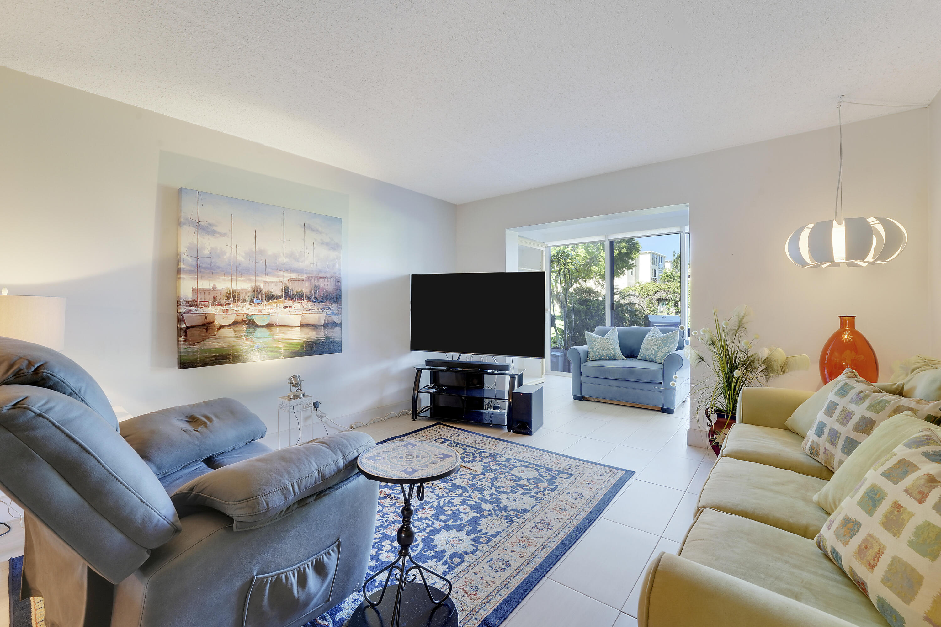2400 Northeast 1st Lane, Unit 1020 Boynton Beach, FL 33435 - Photo 9 of 34 a living room with furniture and a flat screen tv
