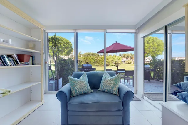 a living room with furniture and a floor to ceiling window