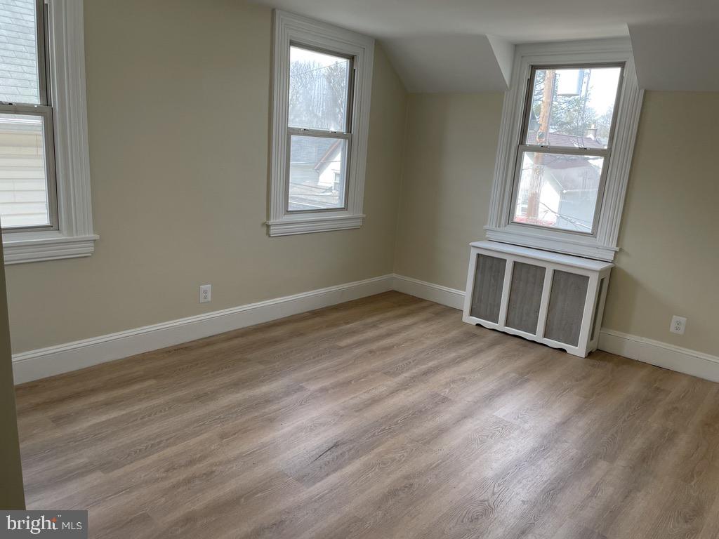 201 Simpson Road Ardmore, PA 19003 - Photo 11 of 37 an empty room with wooden floor and windows