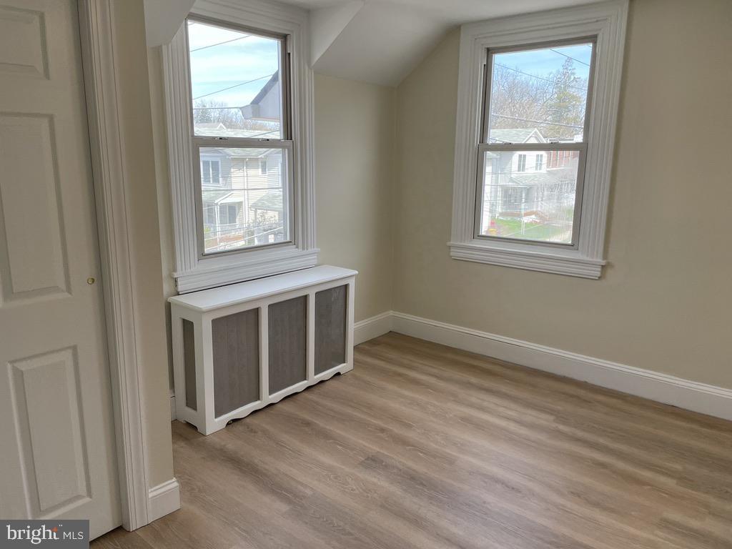 201 Simpson Road Ardmore, PA 19003 - Photo 12 of 37 an empty room with wooden floor and windows