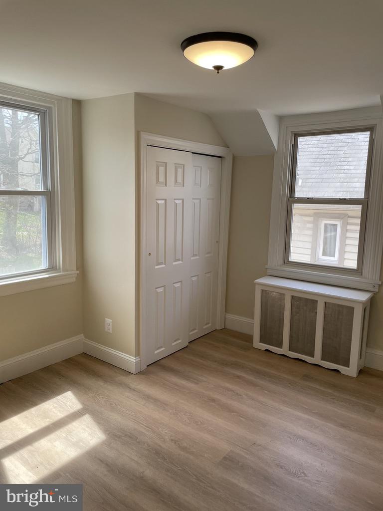 201 Simpson Road Ardmore, PA 19003 - Photo 14 of 37 an empty room with wooden floor and windows