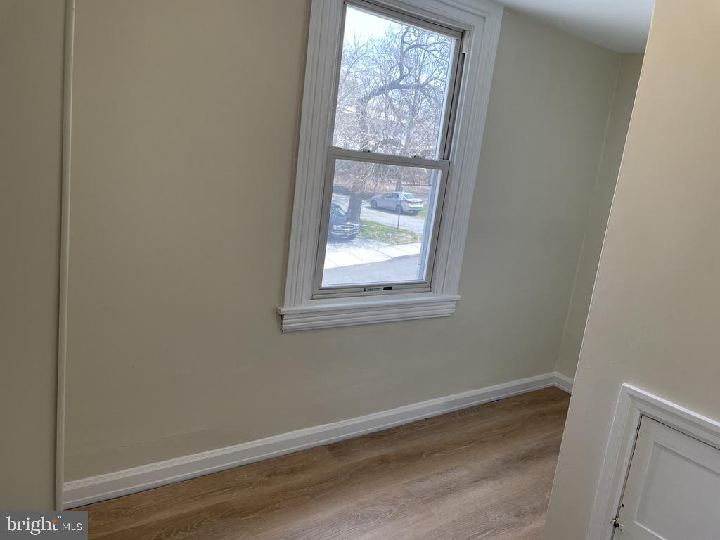 201 Simpson Road Ardmore, PA 19003 - Photo 17 of 37 a view of an empty room with wooden floor and a window