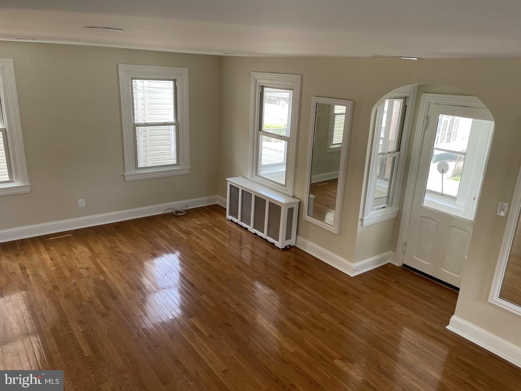 201 Simpson Road Ardmore, PA 19003 - Photo 23 of 37 a view of an empty room with wooden floor and a window