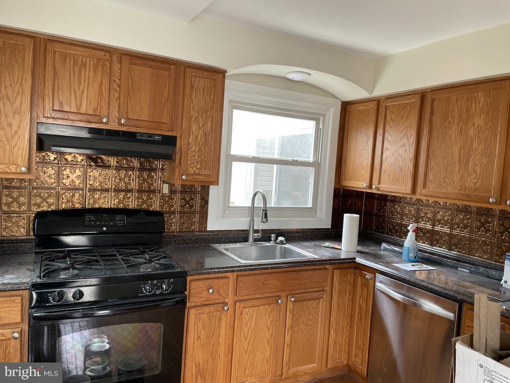 201 Simpson Road Ardmore, PA 19003 - Photo 25 of 37 a kitchen with granite countertop a stove top oven cabinetry a sink and a microwave