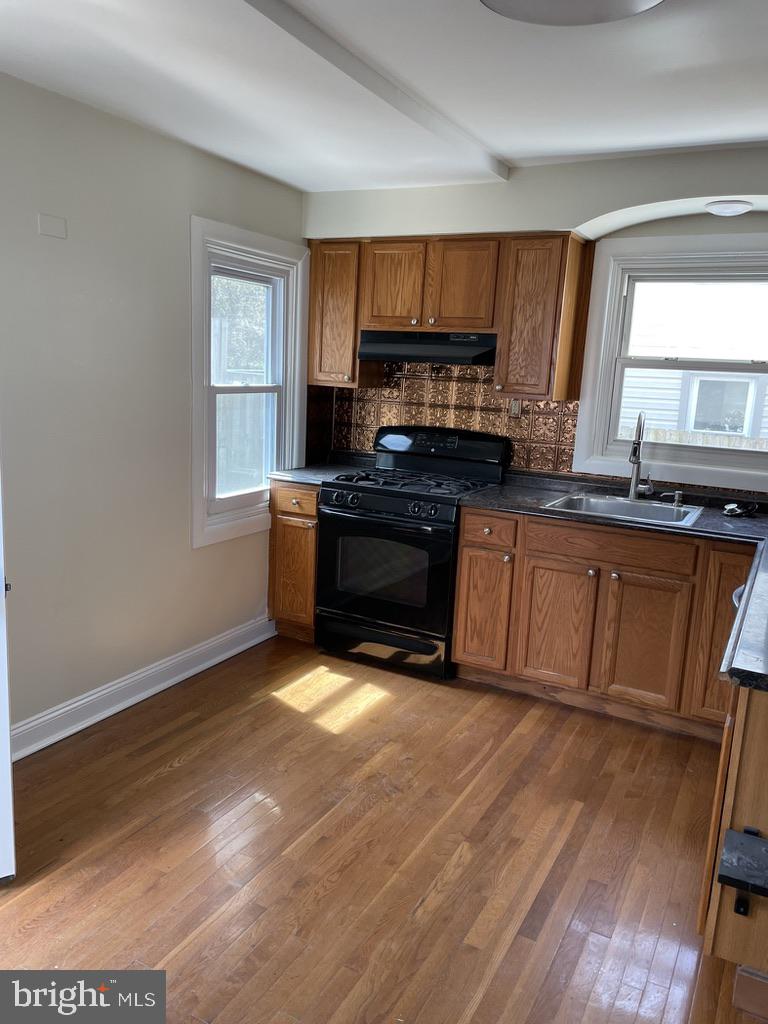 201 Simpson Road Ardmore, PA 19003 - Photo 26 of 37 a kitchen with stainless steel appliances granite countertop a stove a sink and a microwave