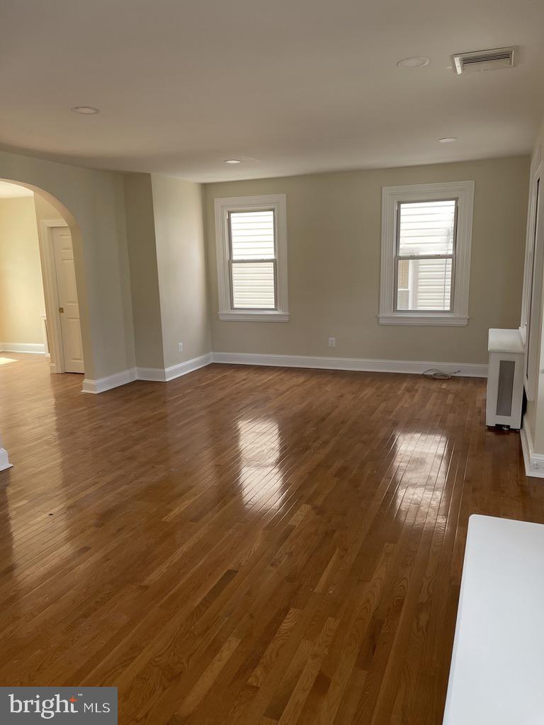 201 Simpson Road Ardmore, PA 19003 - Photo 5 of 37 a view of an empty room with wooden floor and a window