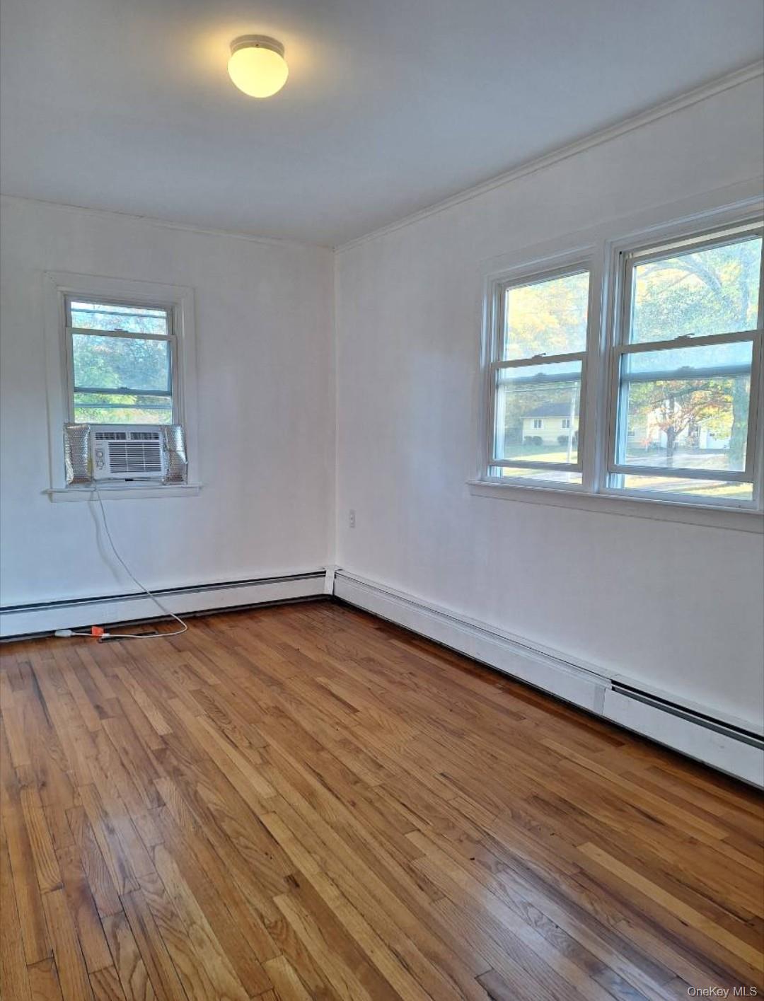 652 Highway 211, Unit 1 Middletown, NY 10940 - Photo 15 of 18 wooden floor in an empty room with a window