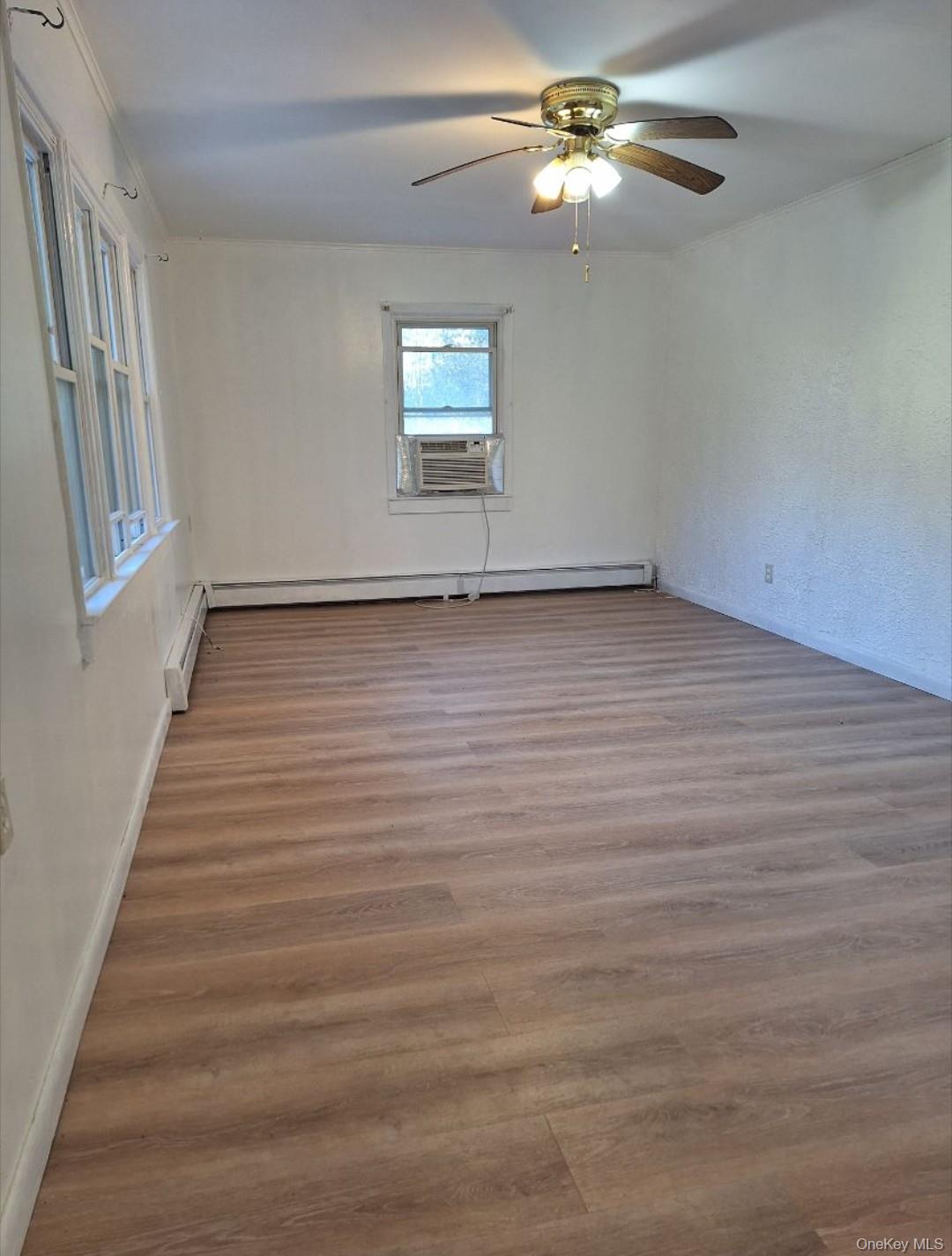 652 Highway 211, Unit 1 Middletown, NY 10940 - Photo 2 of 18 wooden floor in an empty room with a window