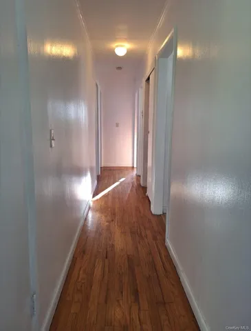 a view of hallway with wooden floor