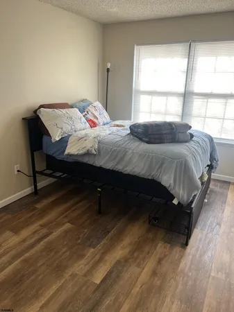 a bedroom with a bed a table and a window