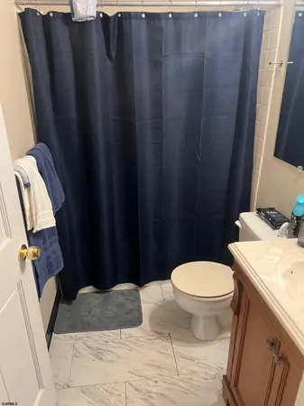 a bedroom with a bed a window and dresser