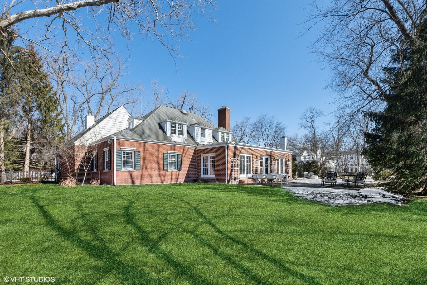 1050 Sunset Road Winnetka, IL 60093 - Photo 2 of 2 a view of a house with a big yard and large trees