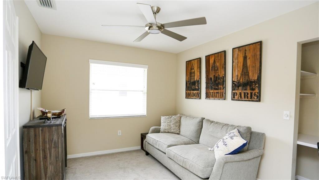 6645 Huntington Lakes Circle, Unit 201 Naples, FL 34119 - Photo 16 of 48 Living room featuring ceiling fan and light colored carpet