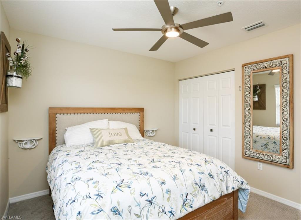 6645 Huntington Lakes Circle, Unit 201 Naples, FL 34119 - Photo 25 of 48 Bedroom with carpet floors, a closet, and ceiling fan