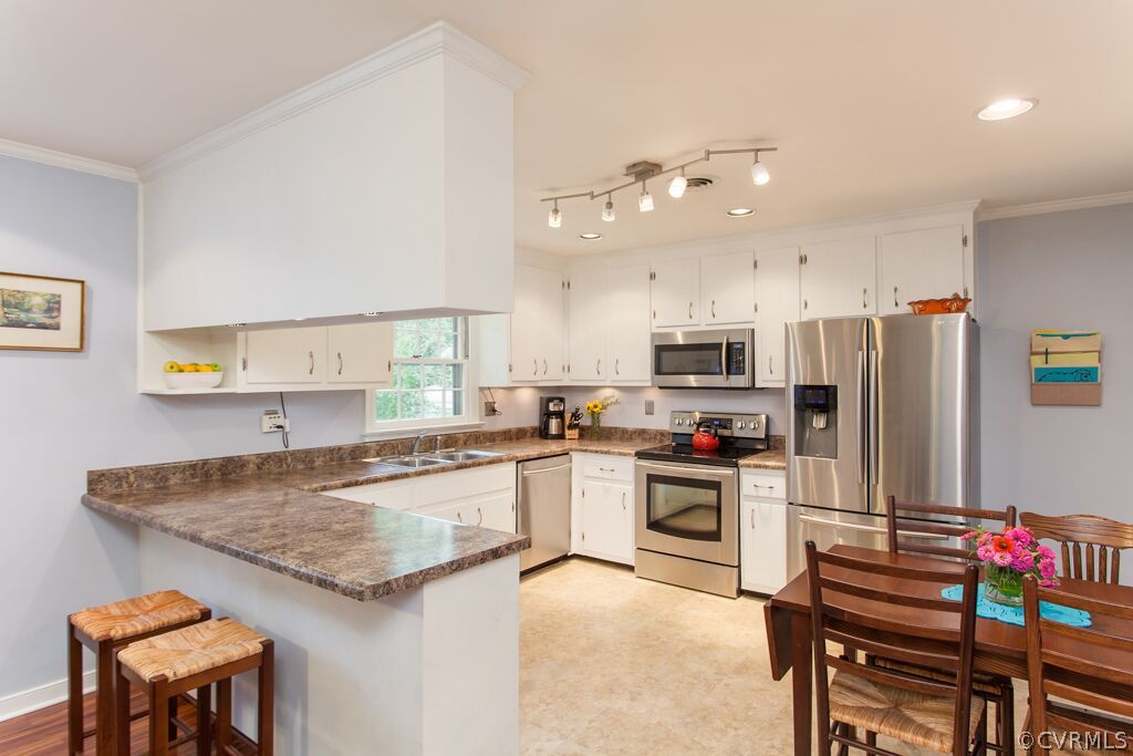 3340 Cheverly Road Richmond, VA 23225 - Photo 8 of 21 a kitchen with refrigerator and cabinets