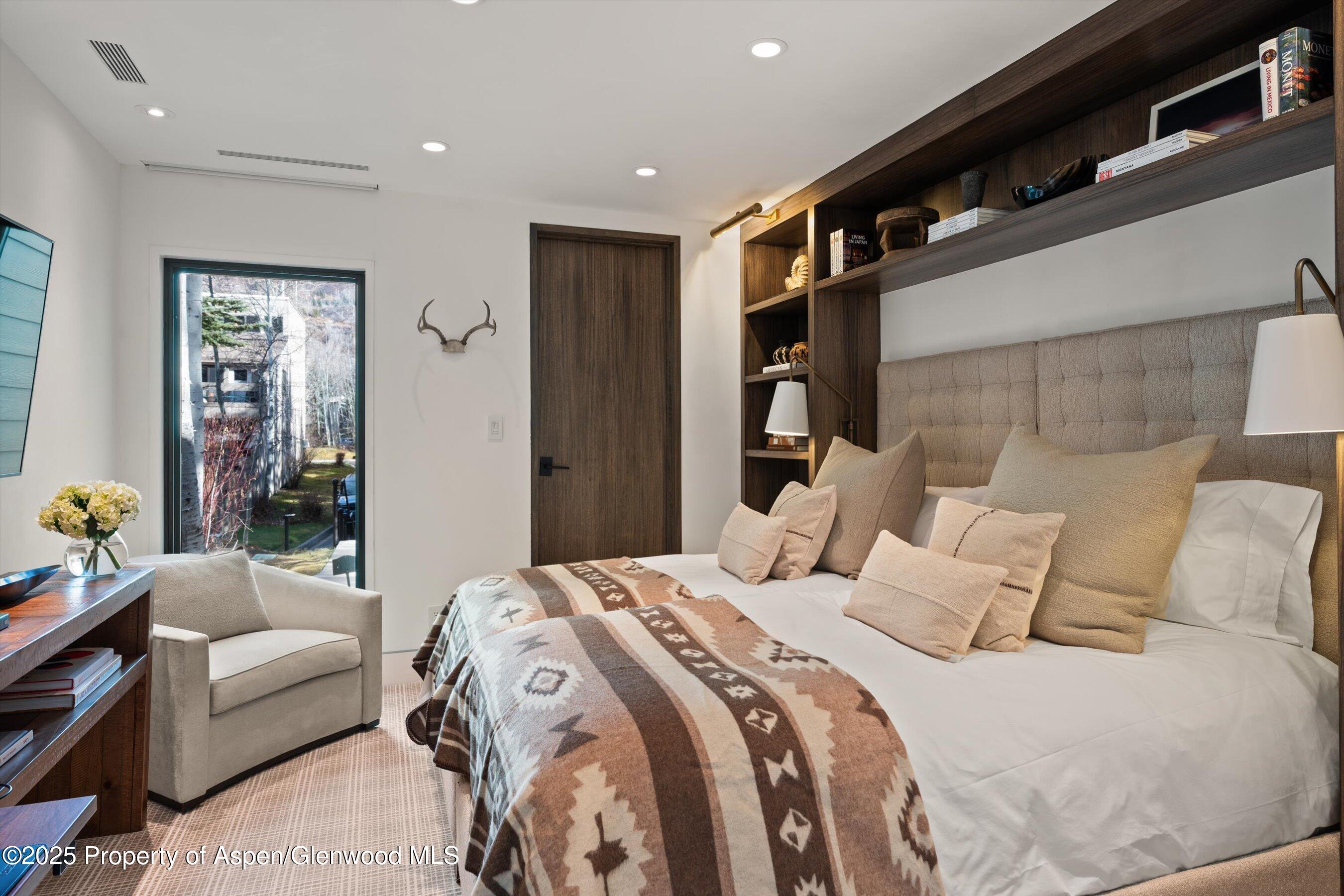 155 Lone Pine Road, Unit 12 Aspen, CO 81611 - Photo 15 of 37 a bedroom with a bed couch and a window