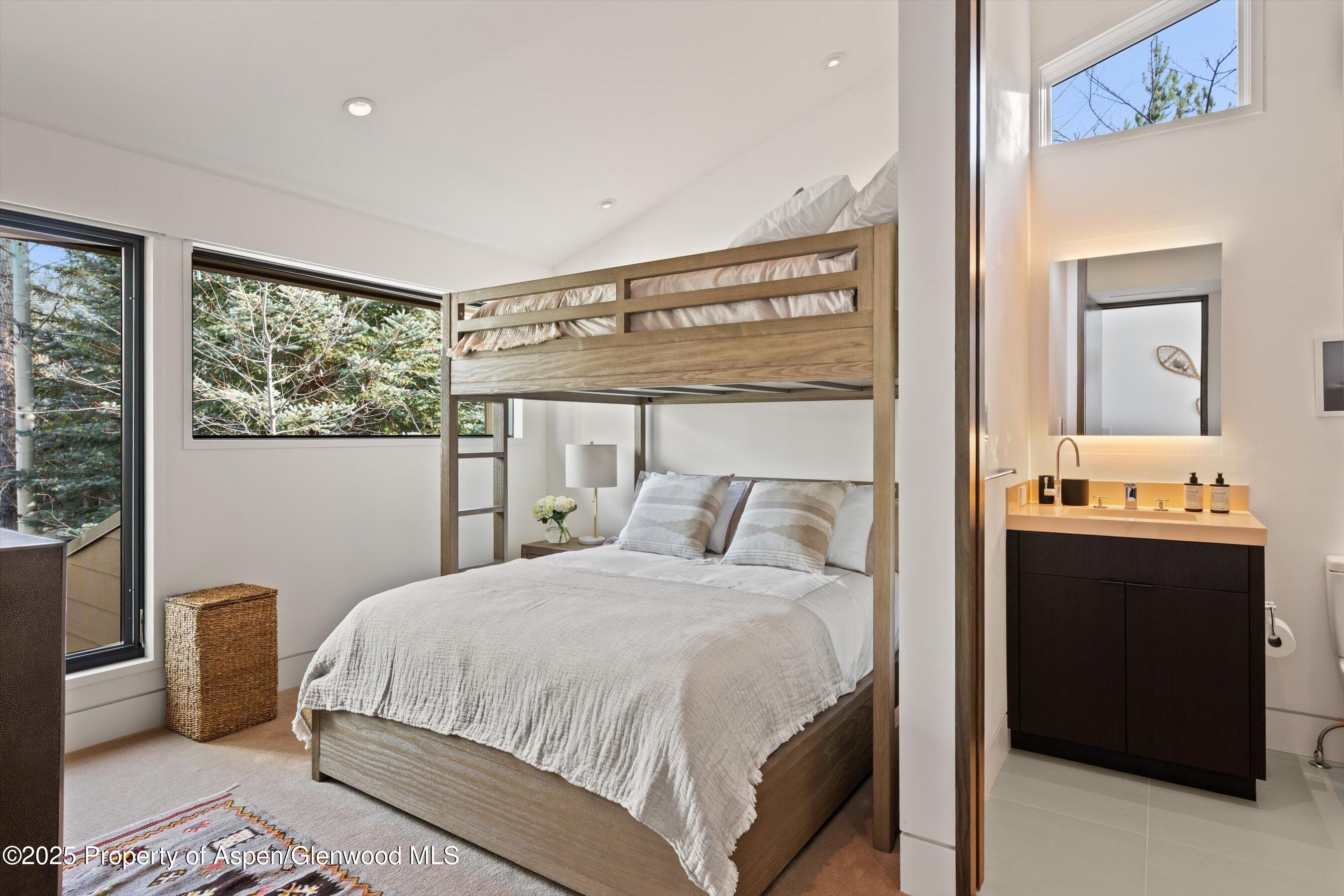 155 Lone Pine Road, Unit 12 Aspen, CO 81611 - Photo 27 of 37 a bedroom with a bed and a large window