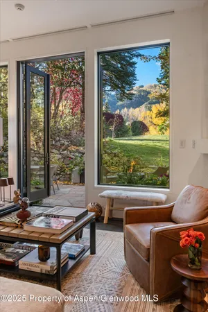a living room with furniture fireplace and large window