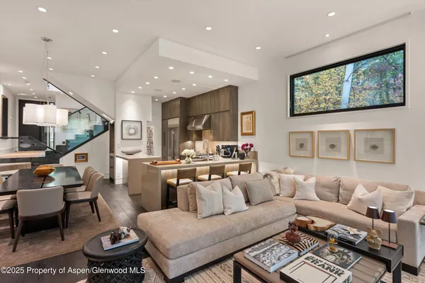 a kitchen with stainless steel appliances granite countertop a sink a stove and a refrigerator
