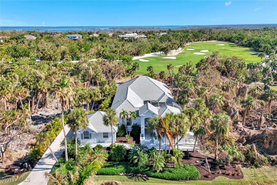 2450 Wulfert Road Sanibel, FL 33957 - Photo 1 of 44 an aerial view of a house with garden space and outdoor seating