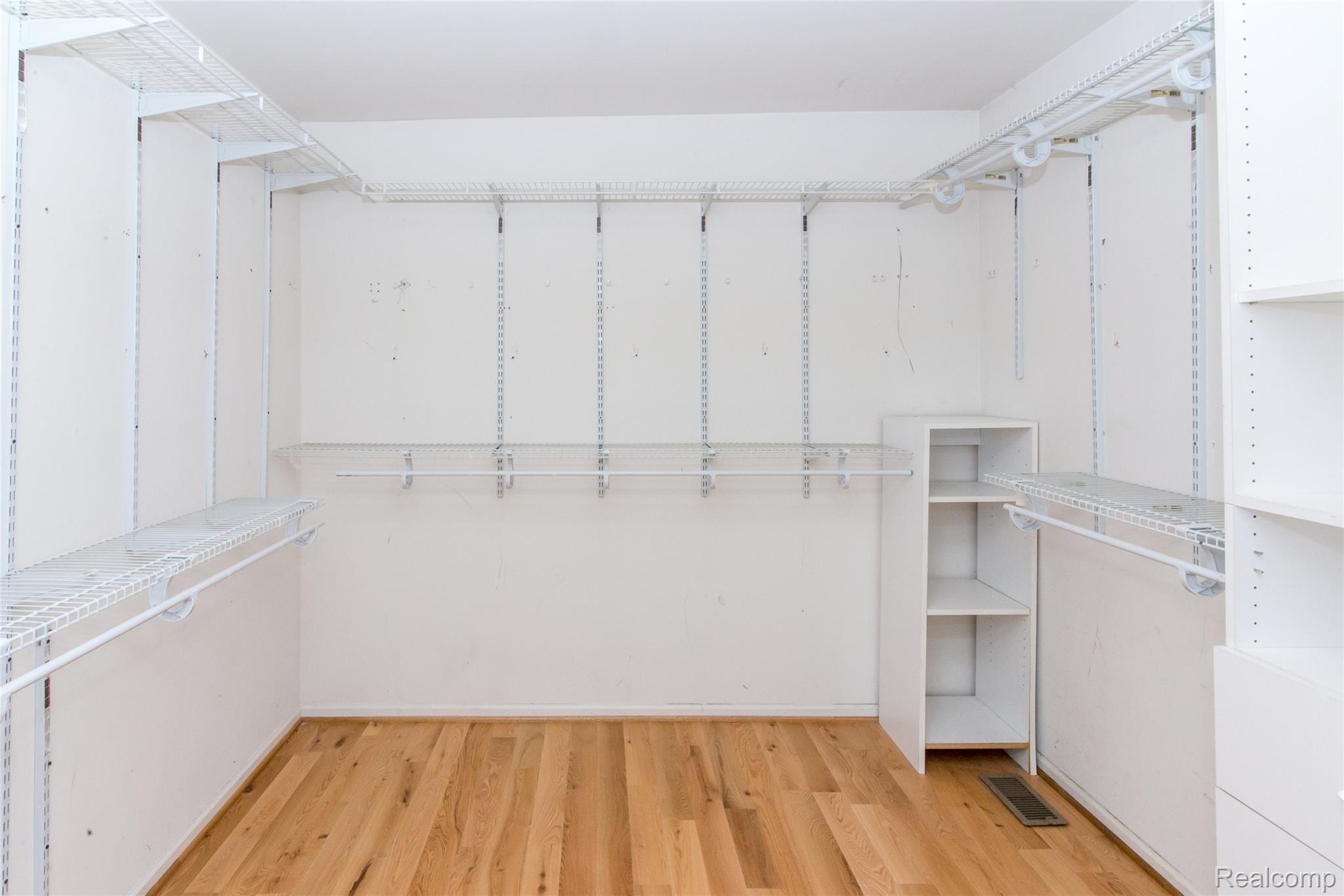 486 Sweet Briar Ridge Linden, MI 48451 - Photo 48 of 69 Spacious closet featuring wood-finish flooring, white shelving, and built-in storage