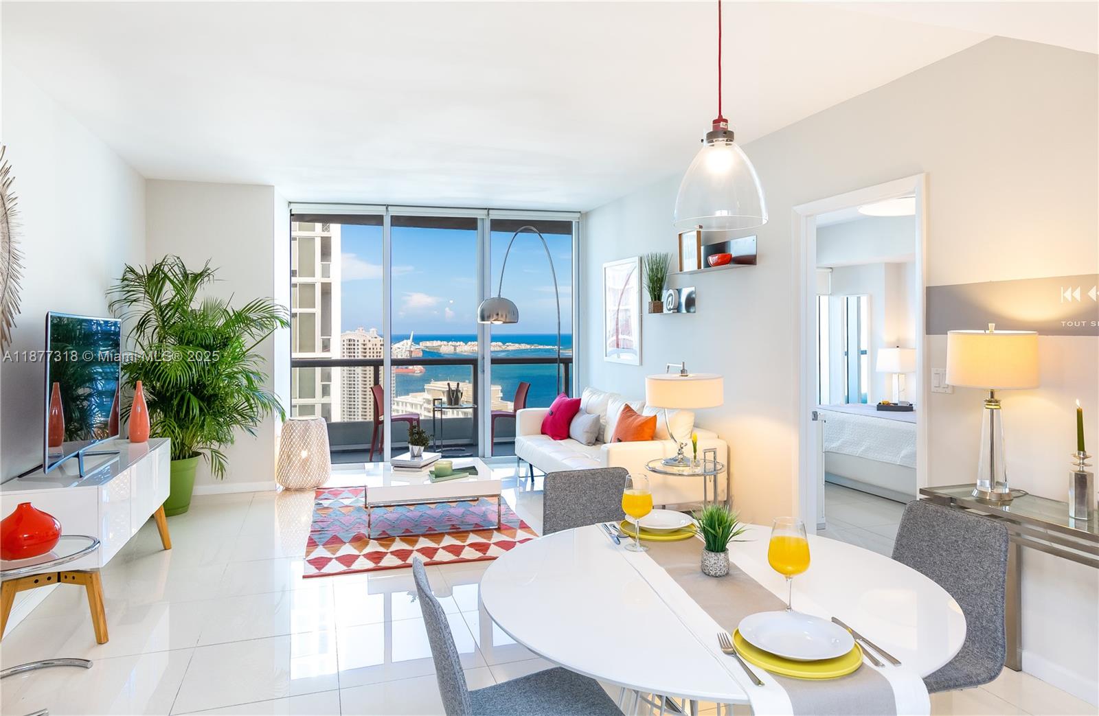 a dining room with furniture and a chandelier