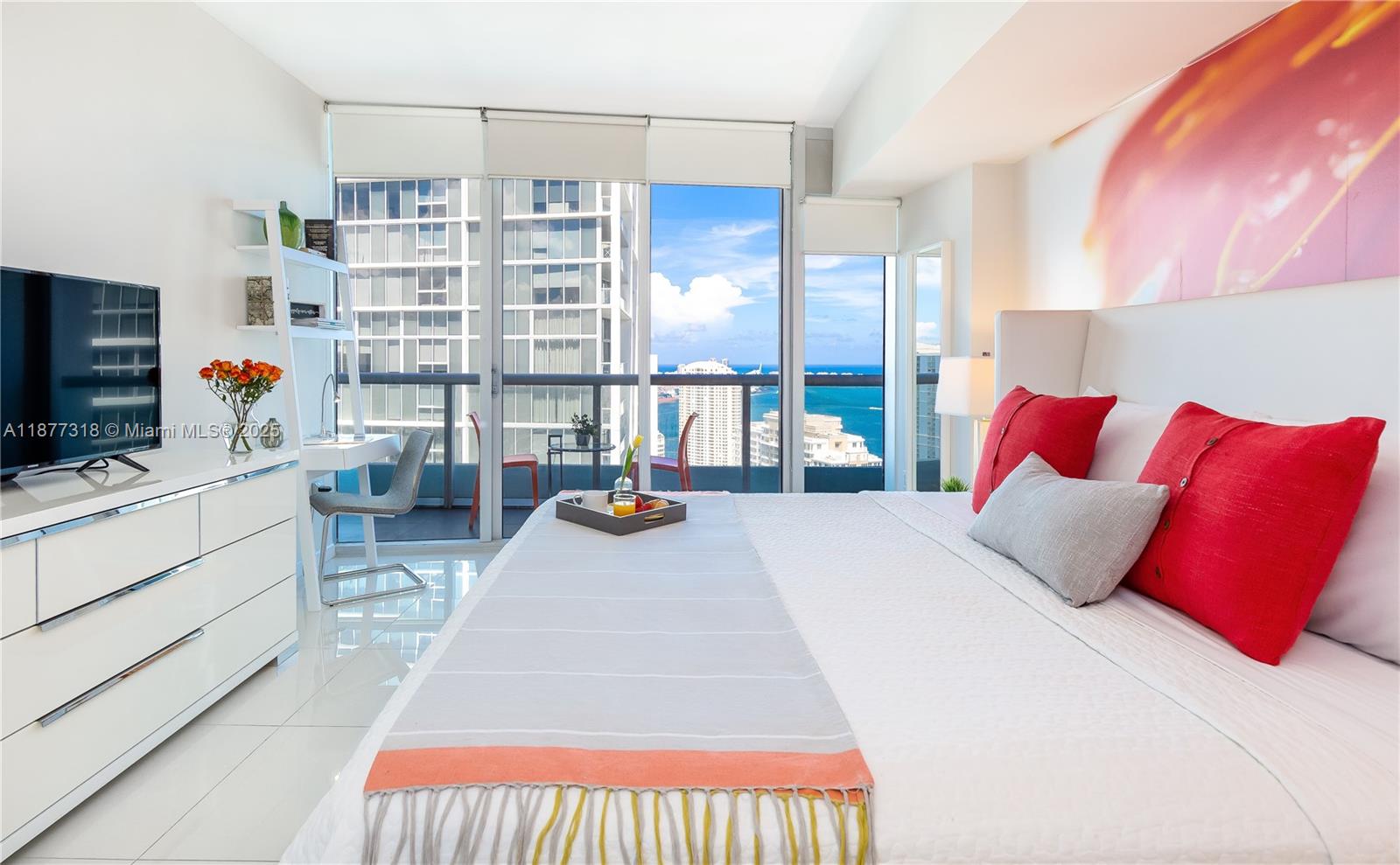 485 Brickell Avenue, Unit 4101 Miami, FL 33131 - Photo 5 of 14 a bedroom with a bed furniture and a flat screen tv