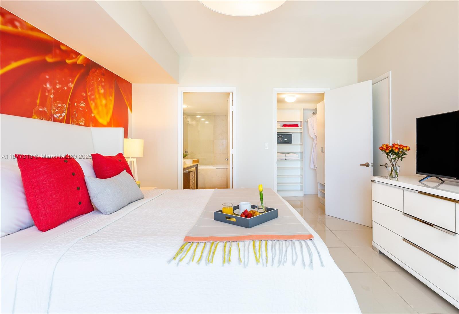 485 Brickell Avenue, Unit 4101 Miami, FL 33131 - Photo 8 of 14 a bedroom with a bed and a flat screen tv