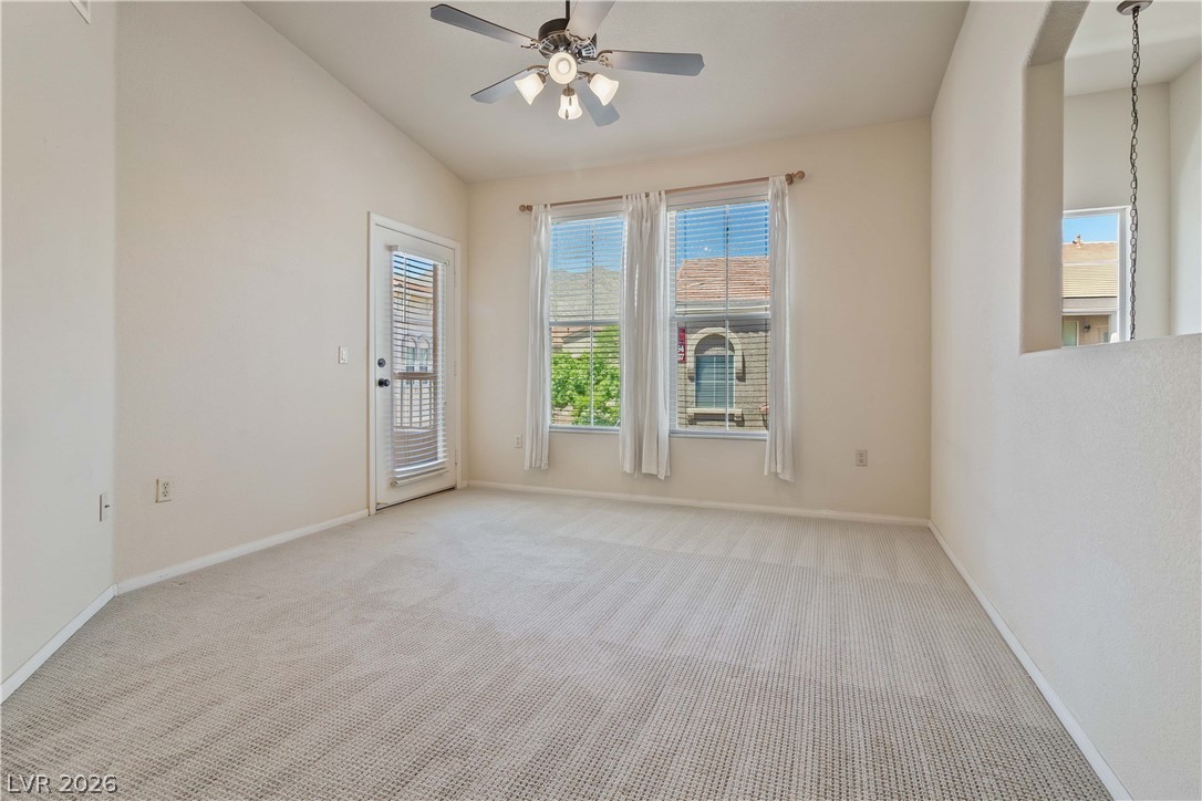 10550 West Alexander Road, Unit 2060 Las Vegas, NV 89129 - Photo 13 of 45 A well-lit sitting area with vaulted ceilings and a private exterior door, perfect for relaxation.