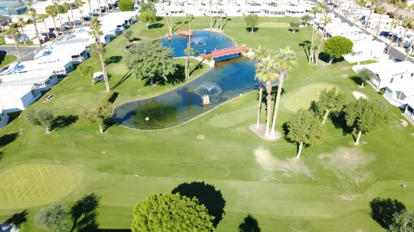 a view of a swimming pool with a yard and outdoor seating