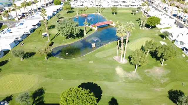a view of a swimming pool with a yard and outdoor seating