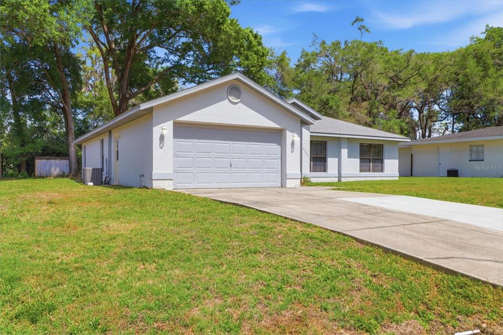 6355 East Rush Street Inverness, FL 34452 - Photo 2 of 27 a view of a house with a yard and large tree