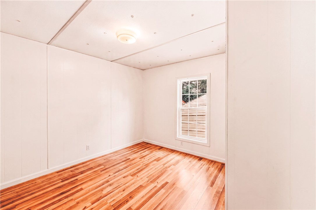 942 Chambers Hill Road Seneca, SC 29672 - Photo 22 of 38 Warm wood floors and a bright window elevate this charming bedroom.