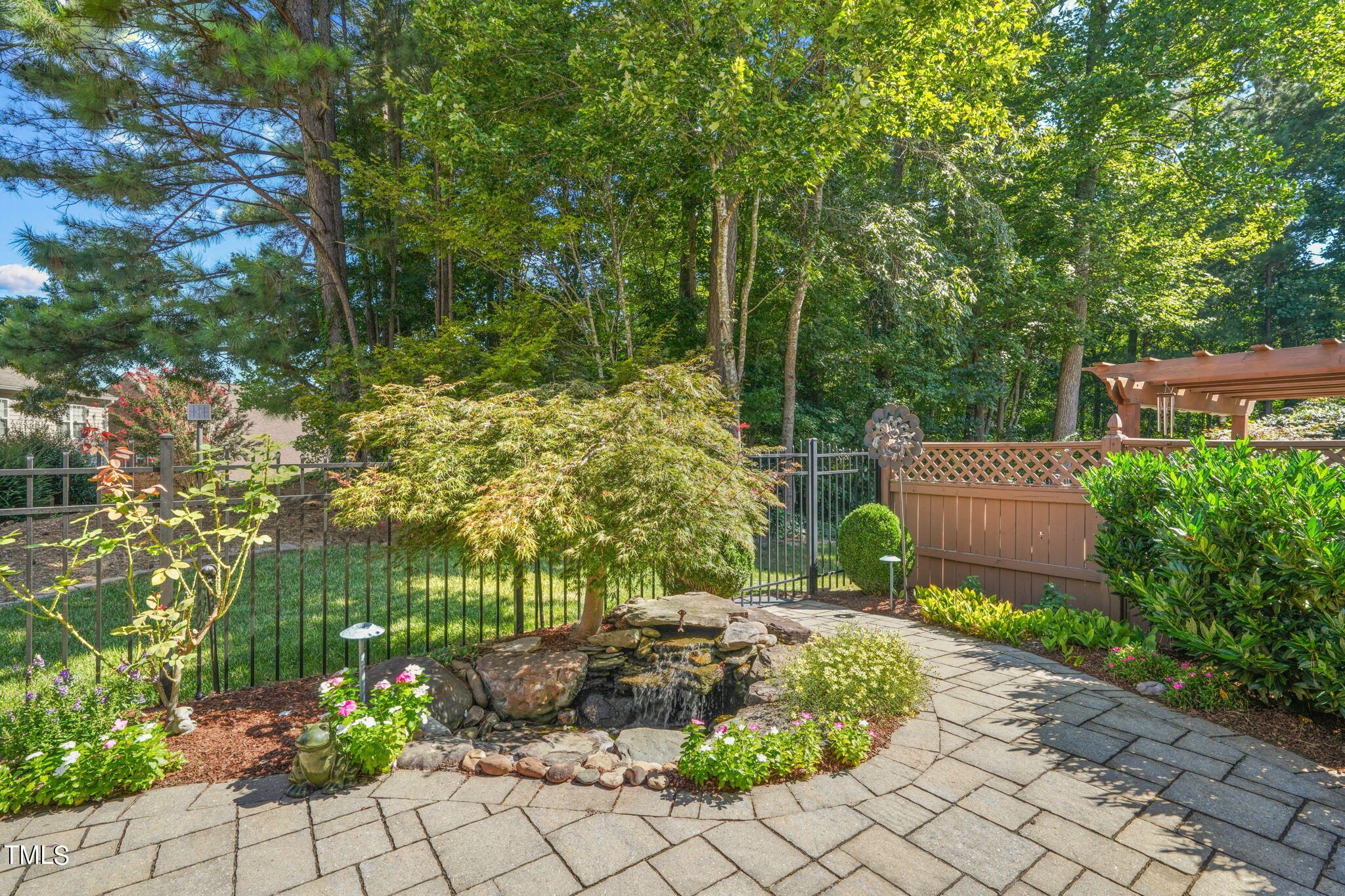 3614 Lion Ridge Court Raleigh, NC 27612 - Photo 45 of 52 a view of a garden with plants and a bench